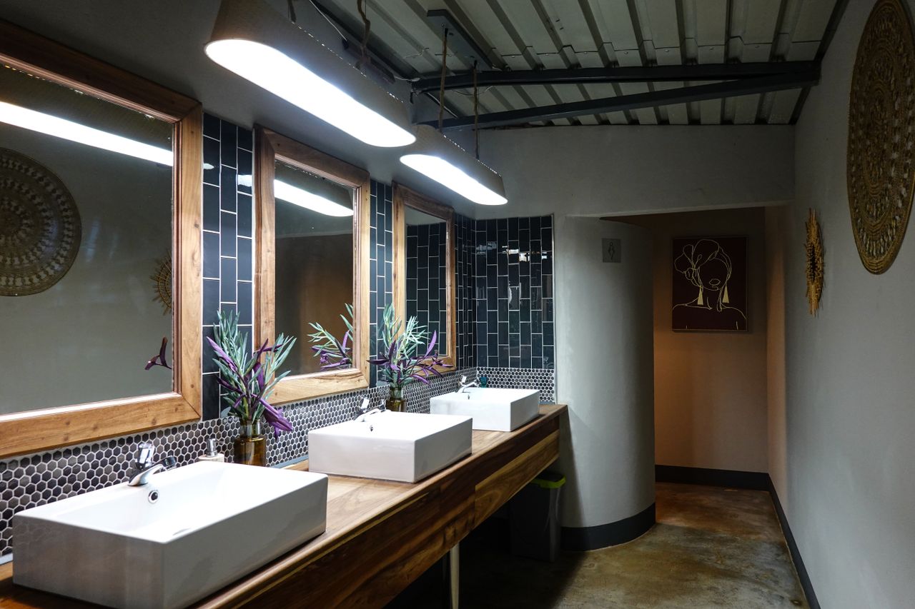 Contemporary bathroom with stylish sinks, mirrors, and decorative elements.