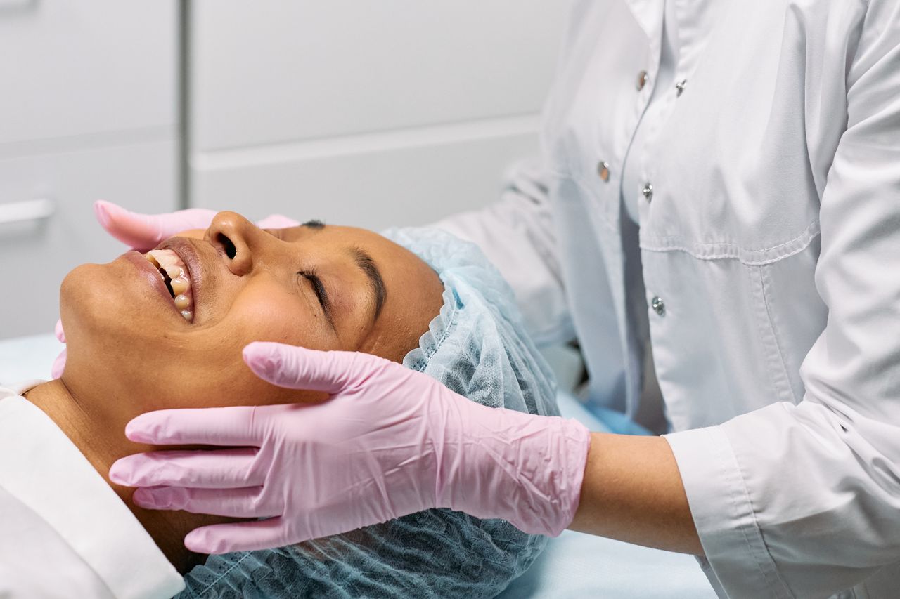 A client receiving a relaxing facial treatment at a modern spa clinic.